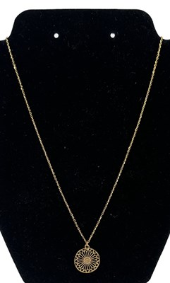 Lot 743 - A 9ct yellow gold necklace suspending a yellow...