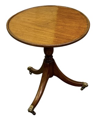 Lot 96 - A mahogany tripod occasional table on brass...