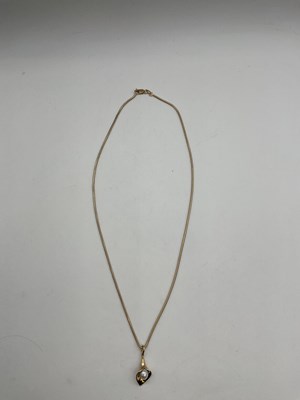 Lot 491 - A 9ct yellow gold chain suspending a 9ct...