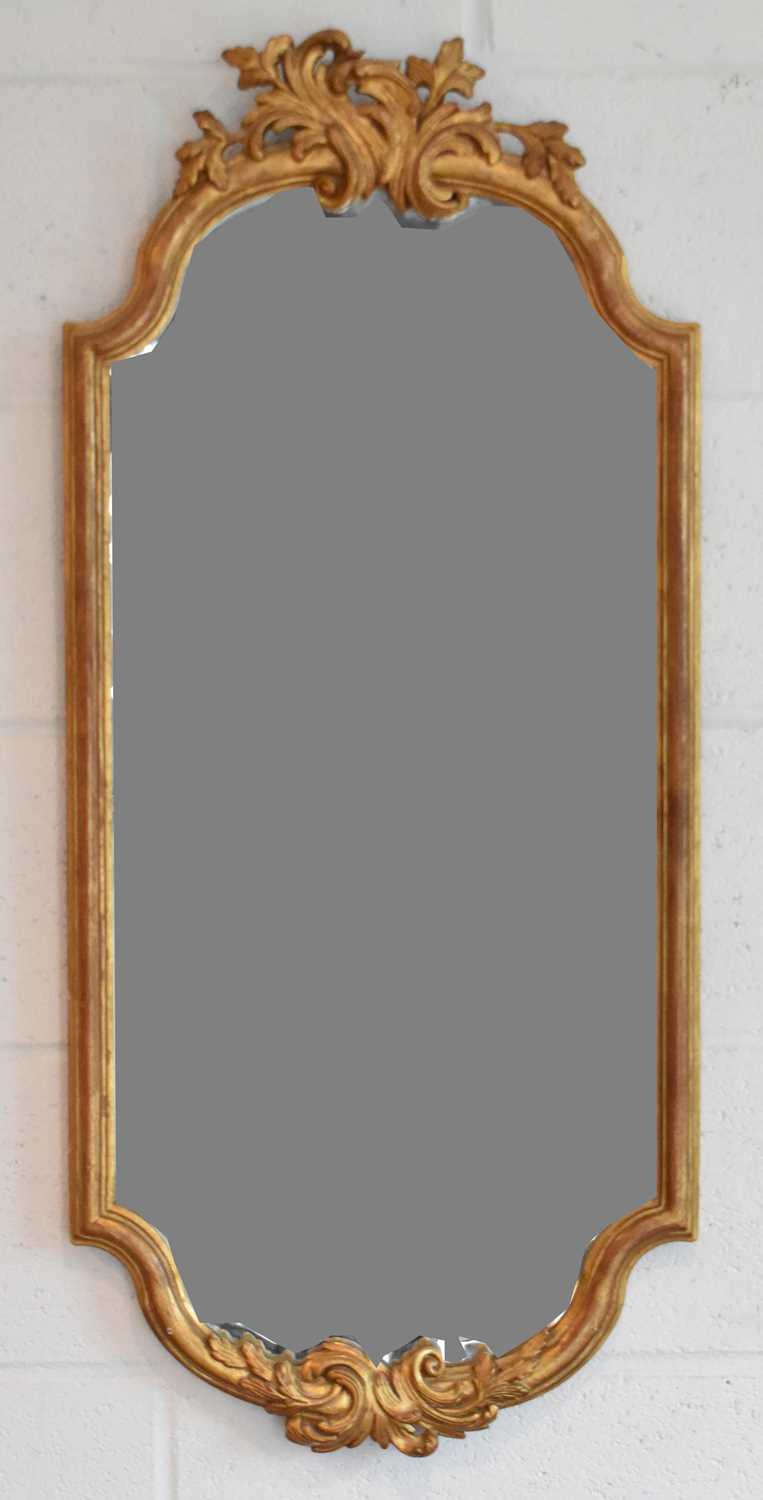 Lot 95 - A decorative gilt framed bevelled wall mirror,...