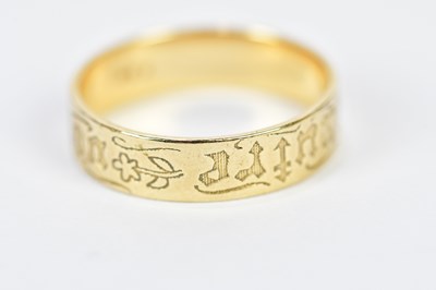 Lot 239 - A yellow metal band, with engraved detail,...