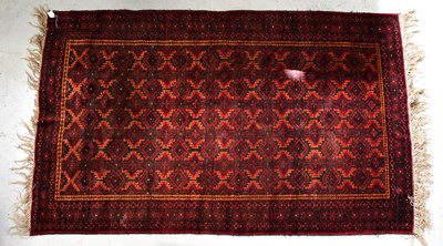 Lot 94 - A Turkmenistan Beluch red ground hand-knotted...