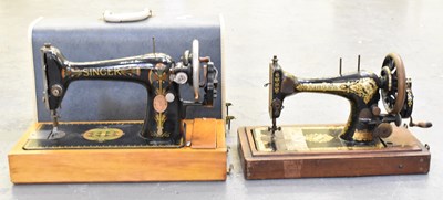 Lot 344 - A cased Singer sewing machine and another...