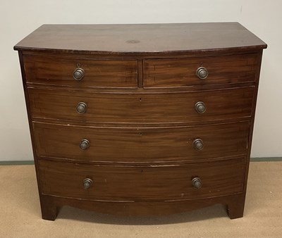 Lot 654 - A mahogany bowfronted chest of two short over...