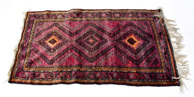 Lot 135 - An Afghan and Turkmen Beluch hand-knotted rug,...