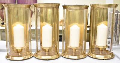 Lot 165 - A set of four decorative gilt metal candle...