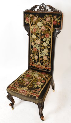 Lot 1583 - A Victorian carved walnut framed prayer chair...