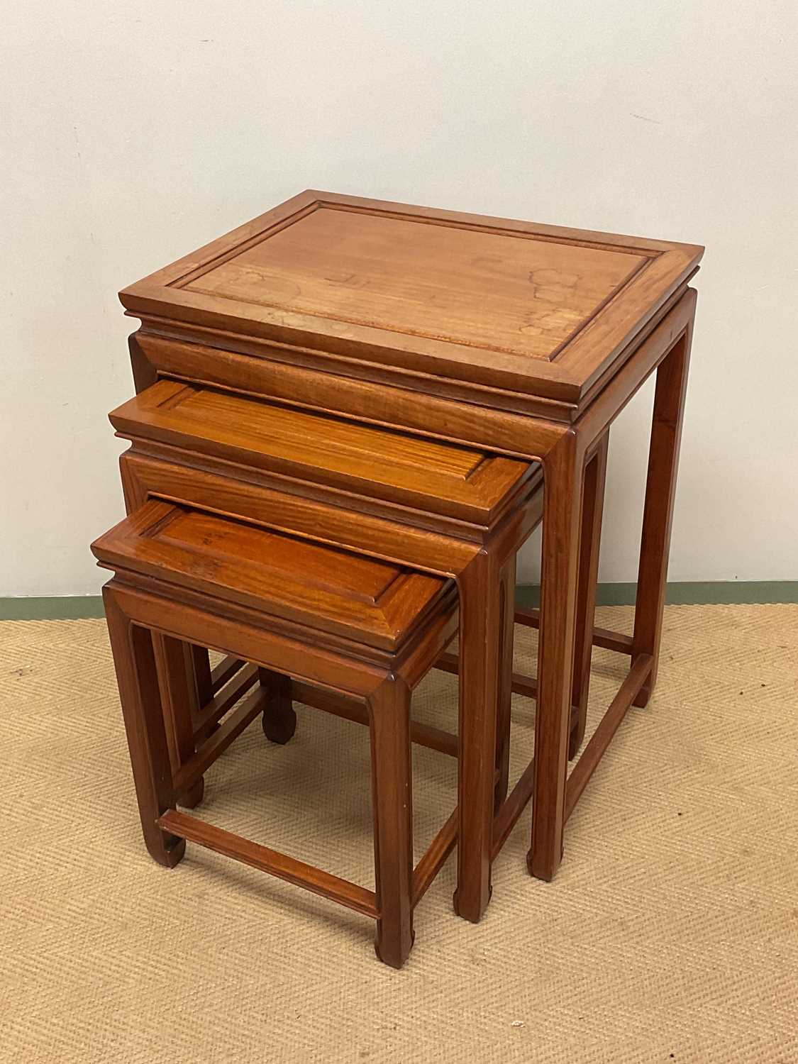 Lot 640 - GEORGE ZEE; a Chinese hardwood nest of tables,...