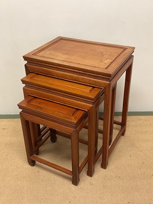 Lot 640 - GEORGE ZEE; a Chinese hardwood nest of tables,...