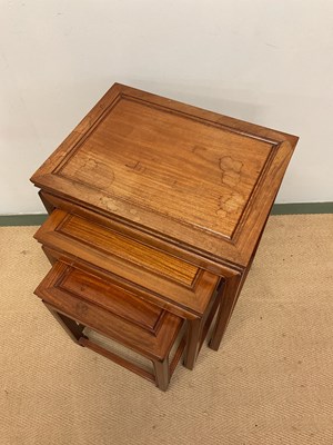 Lot 640 - GEORGE ZEE; a Chinese hardwood nest of tables,...