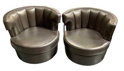 Lot 103 - A pair of modern leather upholstered revolving...