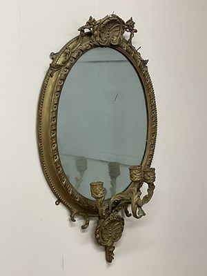 Lot 645 - An oval gilt gesso mirror with decorative...