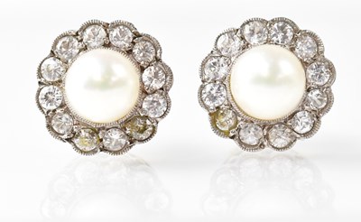 Lot 802 - A pair of stud earrings set with pearls in a...