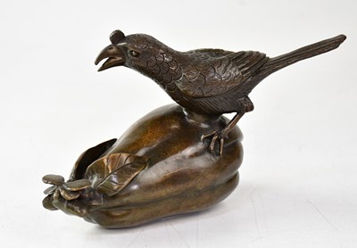 Lot 223 - A Chinese bronze group of a bird perched upon...