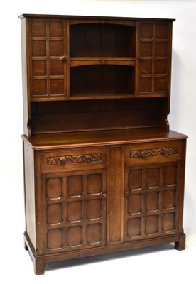 Lot 48 - A reproduction oak dresser, the top with...