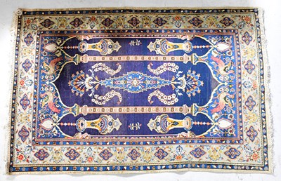 Lot 99 - An Iranian Kashan blue ground hand-knotted rug...