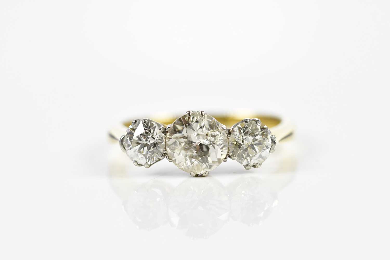 Lot 45 - An 18ct yellow gold three stone diamond ring,...
