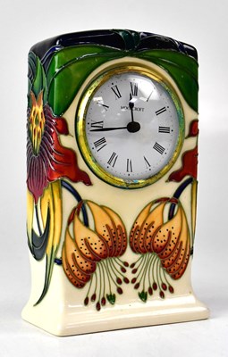 Lot 351 - MOORCROFT; an 'Anna Lily' pattern mantel clock,...