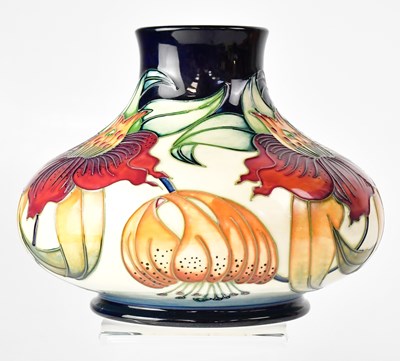 Lot 347 - MOORCROFT; a cream ground squat baluster vase...