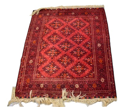 Lot 80 - A hand knotted Afghanistan red ground rug with...