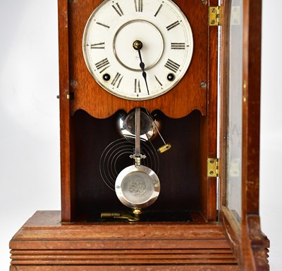 Lot 75 - An American walnut cased mantel clock, the...