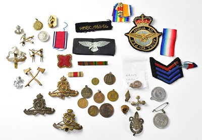 Lot 420 - A collection of military badges and buttons,...