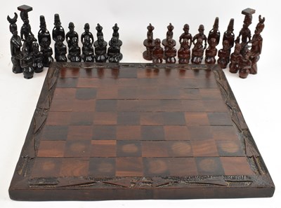 Lot 309 - A hand carved wooden chess set in the Maasai...