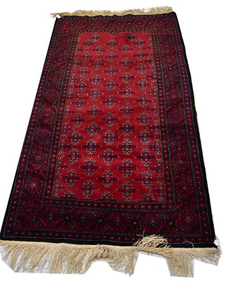 Lot 81 - An Afghan hand knotted Herat Beluch dark red...