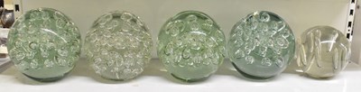 Lot 548 - A set of seven large glass paperweights, with...