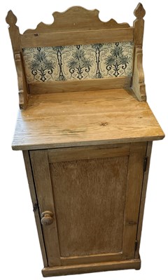 Lot 113 - A small pine washstand with tiled back and...