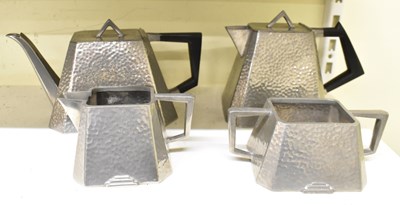 Lot 452 - An Arts and Crafts hammered pewter four piece...