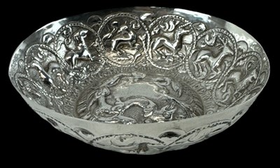 Lot 624 - An Eastern white metal dish, the border...