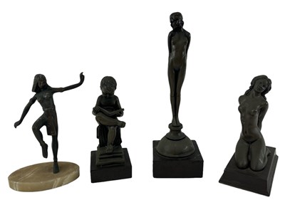 Lot 573 - A group of four decorative resin figures...