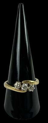 Lot 666 - An 18ct yellow gold three stone diamond ring,...