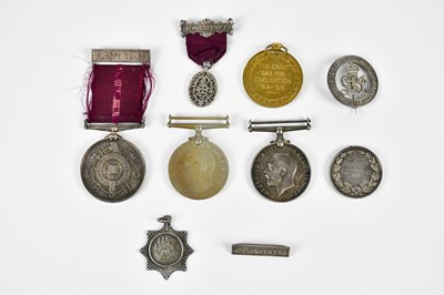 Lot 2603 - A small group of medals and badges, comprising...