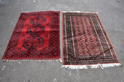 Lot 449 - A Bokhara hand woven wool rug, with three...