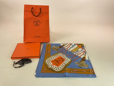 Lot 221 - HERMES; a boxed 'Cliquetis' silk scarf in ciel...