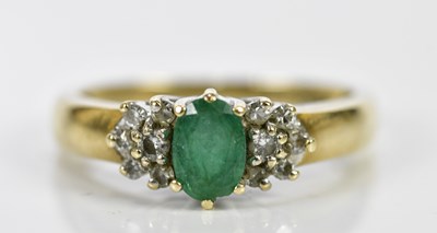 Lot 201 - A yellow metal emerald and diamond dress ring,...