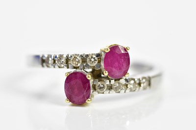 Lot 90 - An 18ct white gold ruby and diamond crossover...