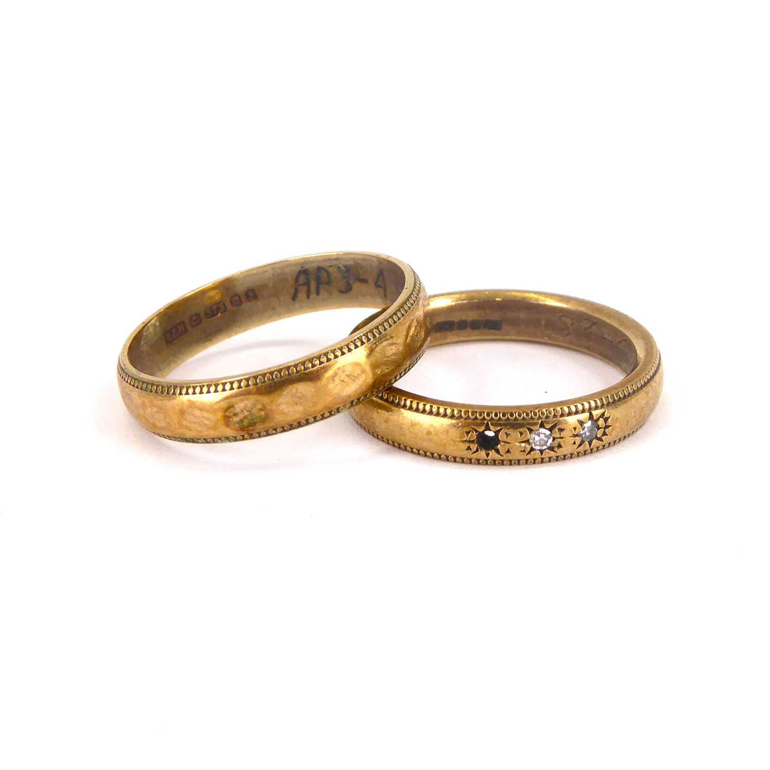 Lot 736 - Two 9ct gold wedding bands, one with three...