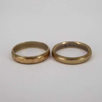 Lot 736 - Two 9ct gold wedding bands, one with three...