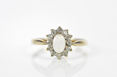 Lot 193 - A 9ct yellow gold opal and diamond dress ring,...