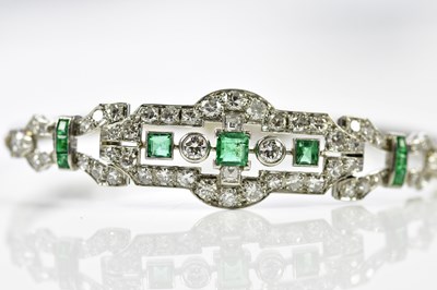 Lot 66 - A white metal Art Deco emerald and diamond...