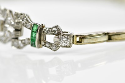 Lot 66 - A white metal Art Deco emerald and diamond...