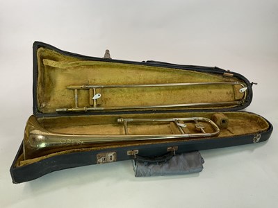 Lot 183 - CORTON; a brass trombone in case, a/ f condition