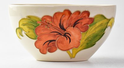 Lot 301 - MOORCROFT; a 'Hibiscus' pattern cream ground...