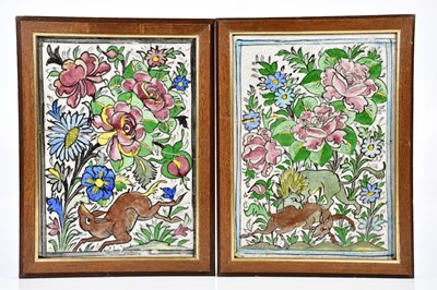 Lot 1295 - A pair of Iznik ceramic tiles decorated with a...