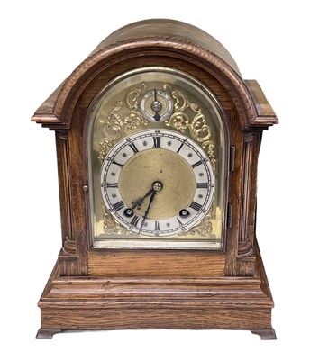 Lot 145 - An early 20th century oak cased mantel clock...