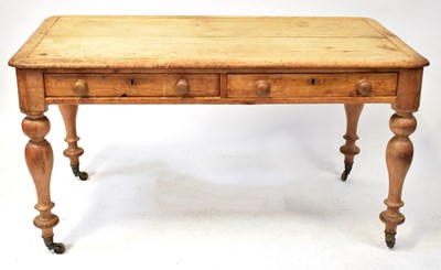 Lot 89 - A rustic pine farmhouse table with two frieze...
