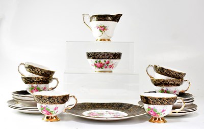 Lot 278 - A porcelain part tea service printed with pink...